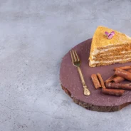 slice-sweet-honey-cake-with-cinnamon-sticks-stone-min (1)